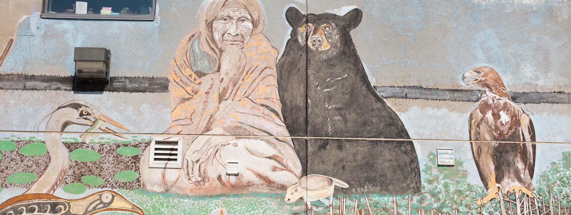 Indigenous art wall mural in Rama, Ontario showing an Elder, black bear, and an eagle
